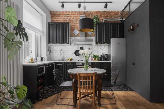 Black kitchen cabinets with brick