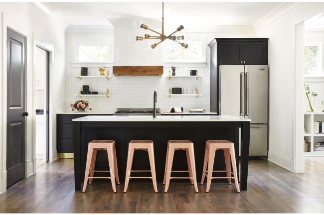 Black cabinets with me<em></em>tallic accents, white tile, and wood features