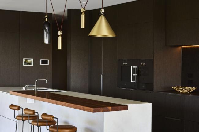 Modern and chic espresso black kitchen with white and wood accents