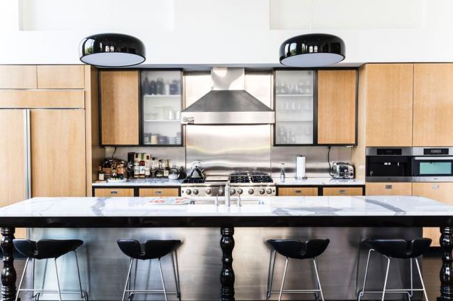 Kitchen with maple colored cabinets and black accents