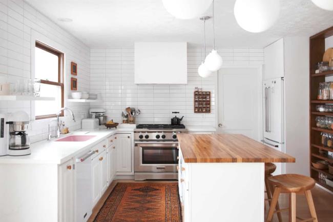 Pink sink in a white kitchen