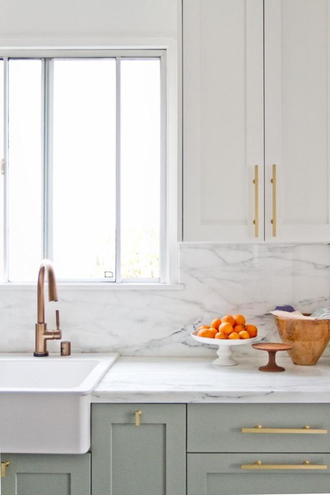 kitchen with pastel cabinets and gold hardware