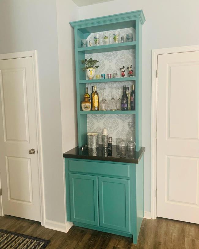 Wet bar with dark gray cabinets 