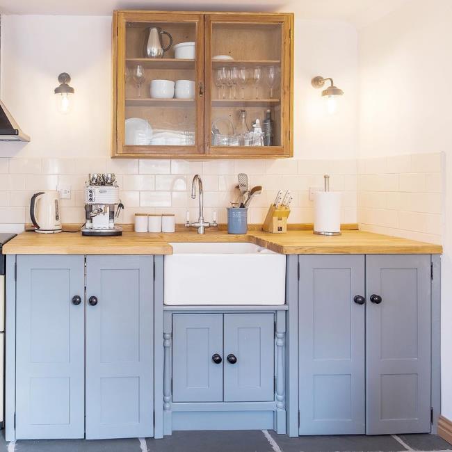 Light blue kitchen with wood countertops