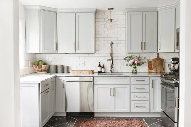 kitchen with subway tile and light gray cabinet