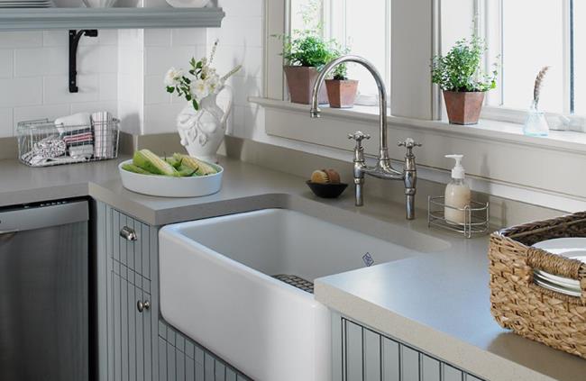 Thick gray solid surface countertop in bead board kitchen