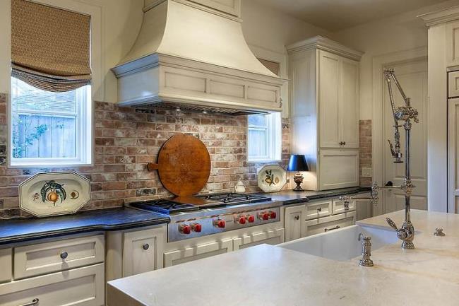 distressed and antiqued white kitchen cabinets