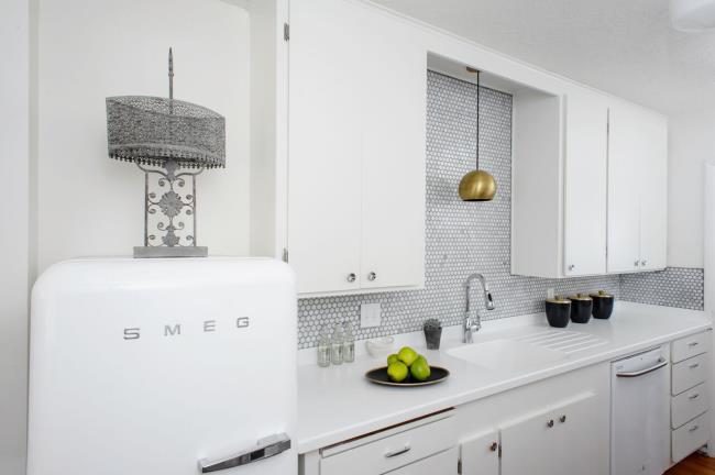 nautical kitchen with white cabinets and shiplap flooring