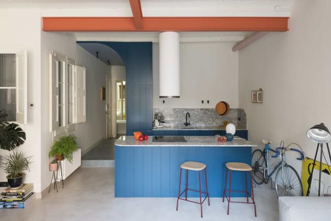 Sleek modern kitchen in Spain with blue shiplap