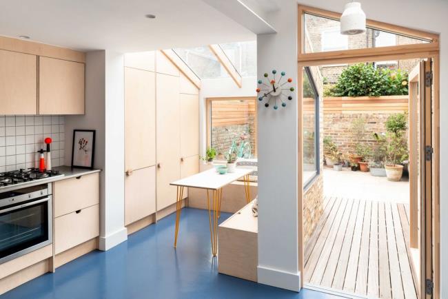 sleek natural wood kitchen with blue rubber floor