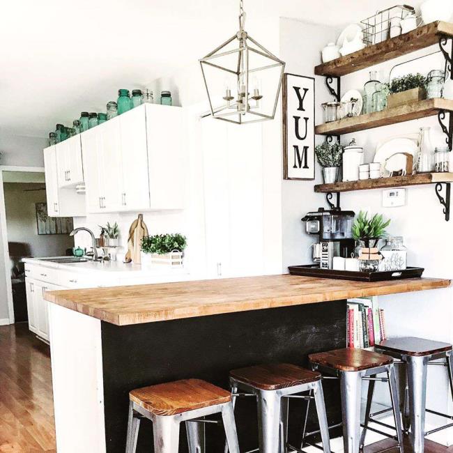 White kitchen with a black and wooden kitchen island