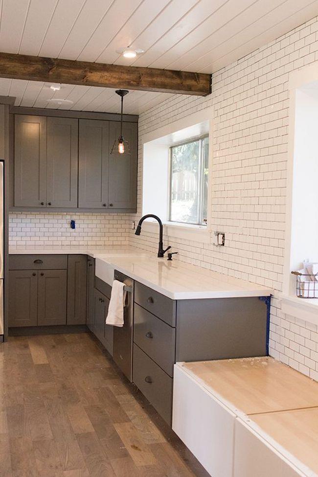 subway tile in a kitchen with beams