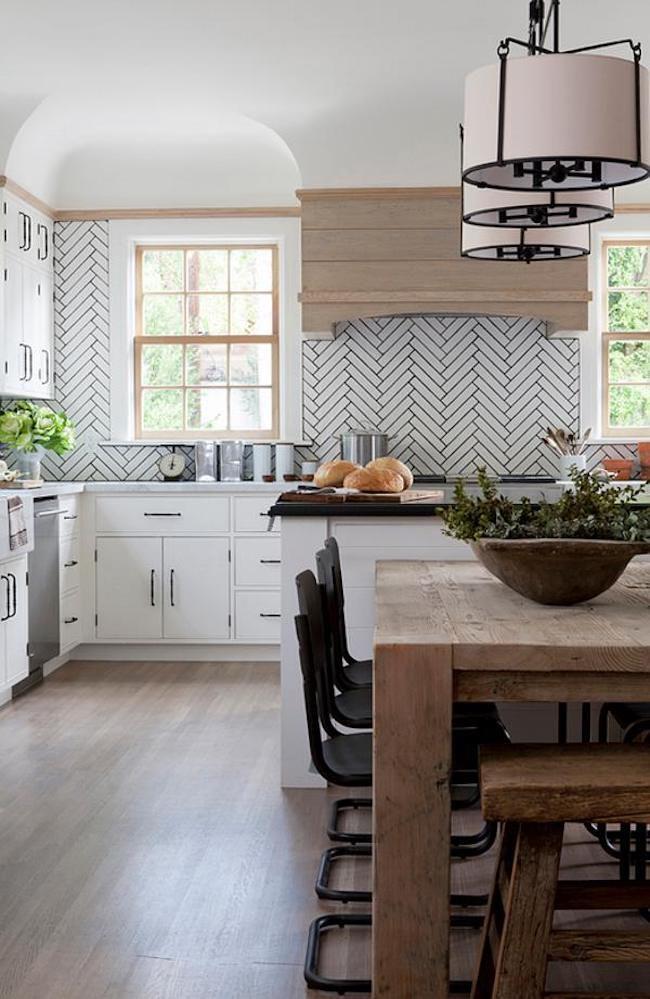 kitchen with wood table and chevron tiles