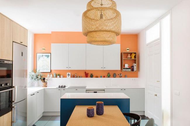 Apple green and white kitchen with golden pendant lights.