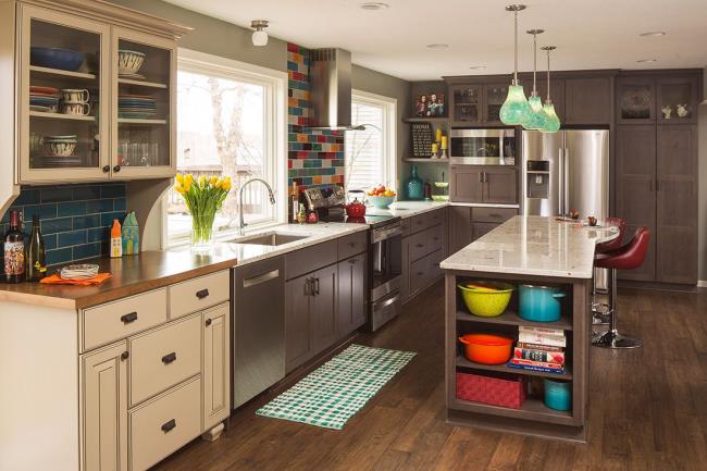 Colorful subway tile adorns the walls of this brown kitchen.