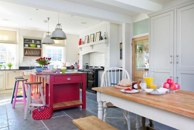 Red modern kitchen with red cabinets, walls, and backsplash.