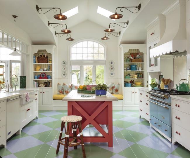 Colorful stenciled green kitchen floor in a white kitchen.