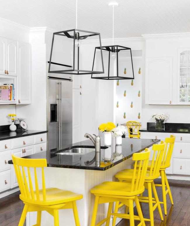 Pineapple kitchen with four yellow chairs.