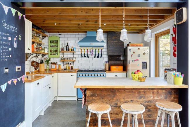 Crazy colorful rustic kitchen with chalkboard wall.