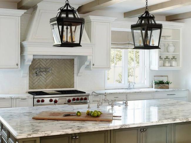 White French country kitchen with large island and hanging pendant lights.