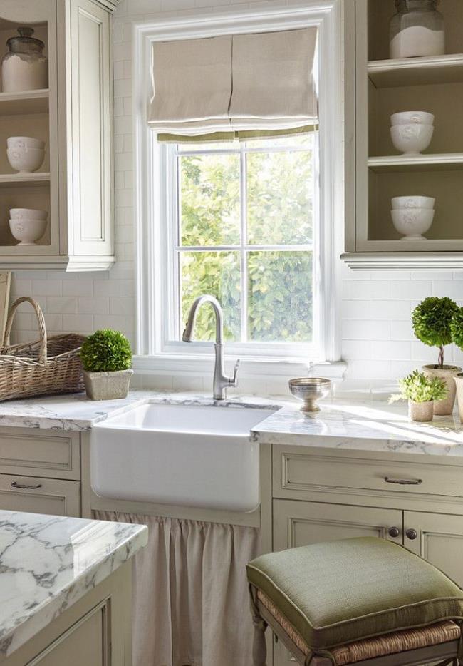 French country kitchen with open cabinets and window overlooking the sink.