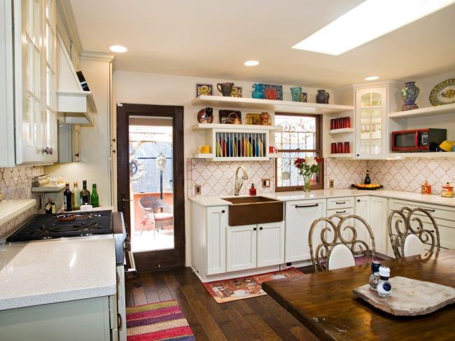 French country kitchen with yellow wall tile and an island with pendant lights.