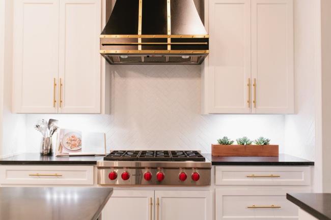 Chic French country kitchen with the focus on the stove and range hood.