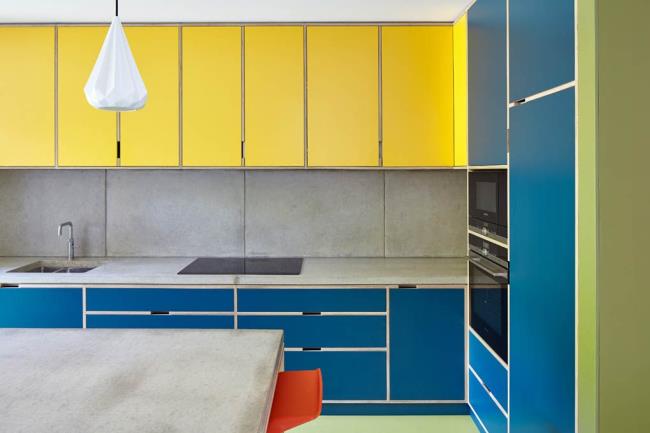 yellow and blue kitchen with co<em></em>ncrete countertops