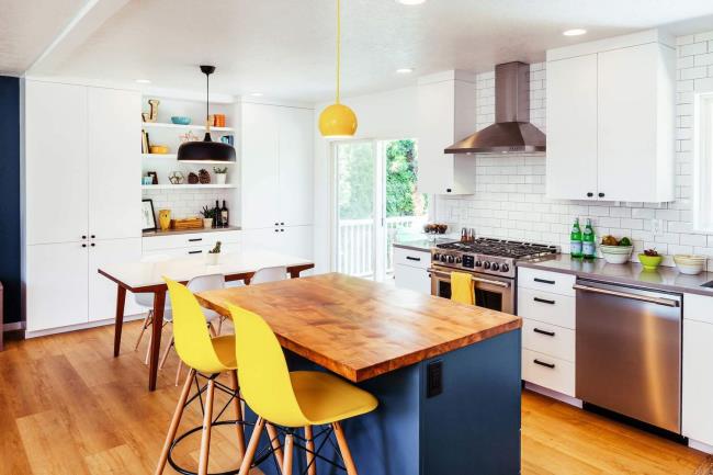 pops of yellow in white and blue kitchen