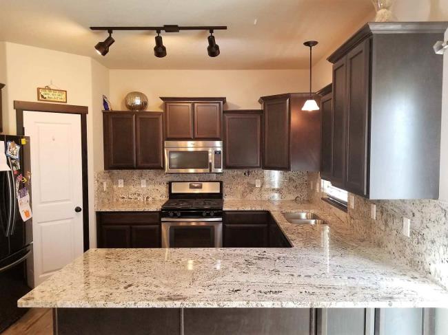 Brown and cream traditio<em></em>nal kitchen with granite countertops