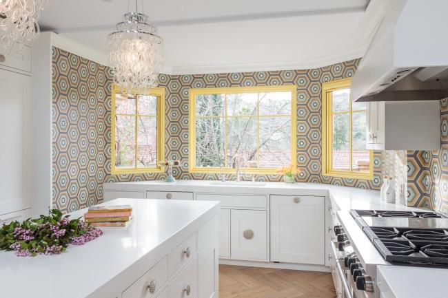 Colorful tile creates a feature wall in a white kitchen.