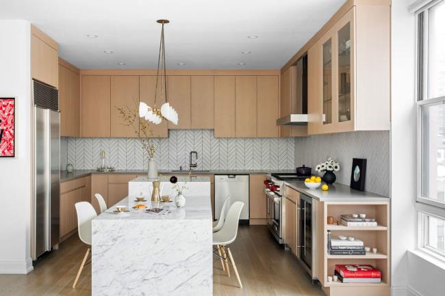 Two different quartz countertops in a kitchen with brown cabinets.