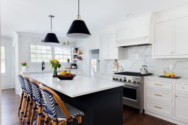 Marble and quartz kitchen with blue-and-white chairs.