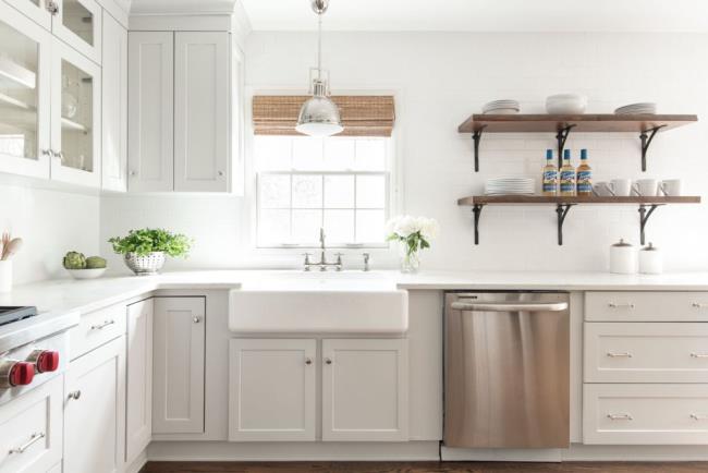 Soft gray quartz countertops with white kitchen and stainless steel dishwasher.