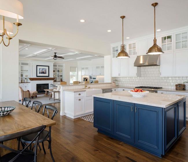 Two tone quartz countertops with blue cabinets.