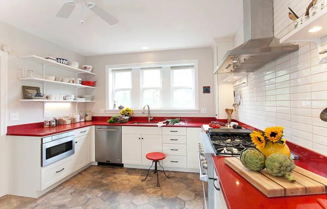 Red quartz countertop in a white kitchen.