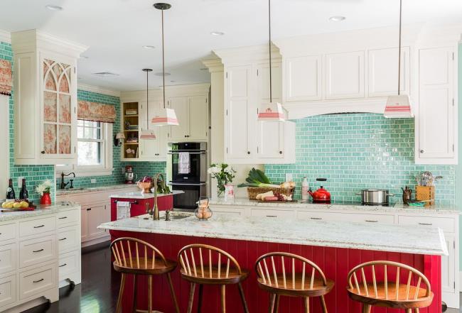 kitchen with teal backsplash and red island