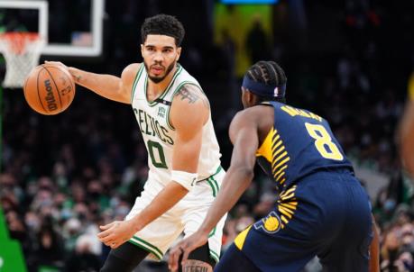 Jan 10, 2022; Boston, Massachusetts, USA; Boston Celtics forward Jayson Tatum (0) looks for an opening against Indiana Pacers forward Justin Holiday (8) in overtime at TD Garden. Mandatory Credit: David Butler II-USA TODAY Sports