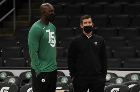 Jan 25, 2022; Boston, Massachusetts, USA; Boston Celtics president of basketball operations Brad Stevens (right) watches warm-ups with player development staff member Steve Tchiengang before their game against the Sacramento Kings at TD Garden. Mandatory Credit: Winslow Townson-USA TODAY Sports